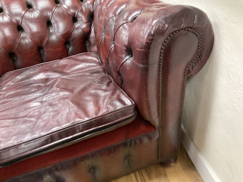 A Victorian style buttoned burgundy leather three seater Chesterfield settee, width 190cm depth 85cm height 72cm